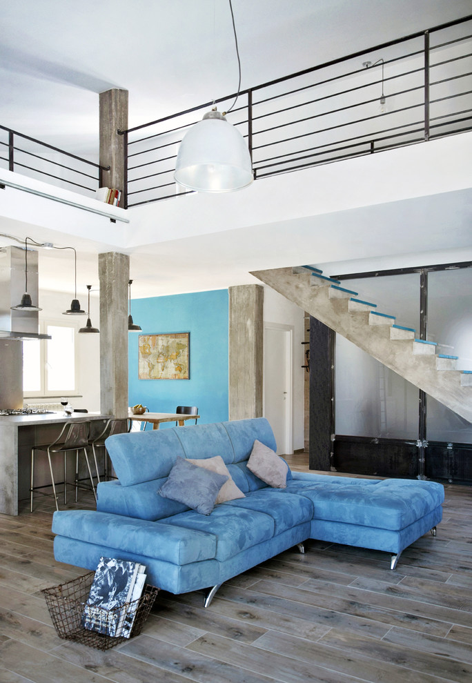 Inspiration for a mid-sized industrial formal open concept living room in Other with white walls, medium hardwood floors, no fireplace, no tv and brown floor.