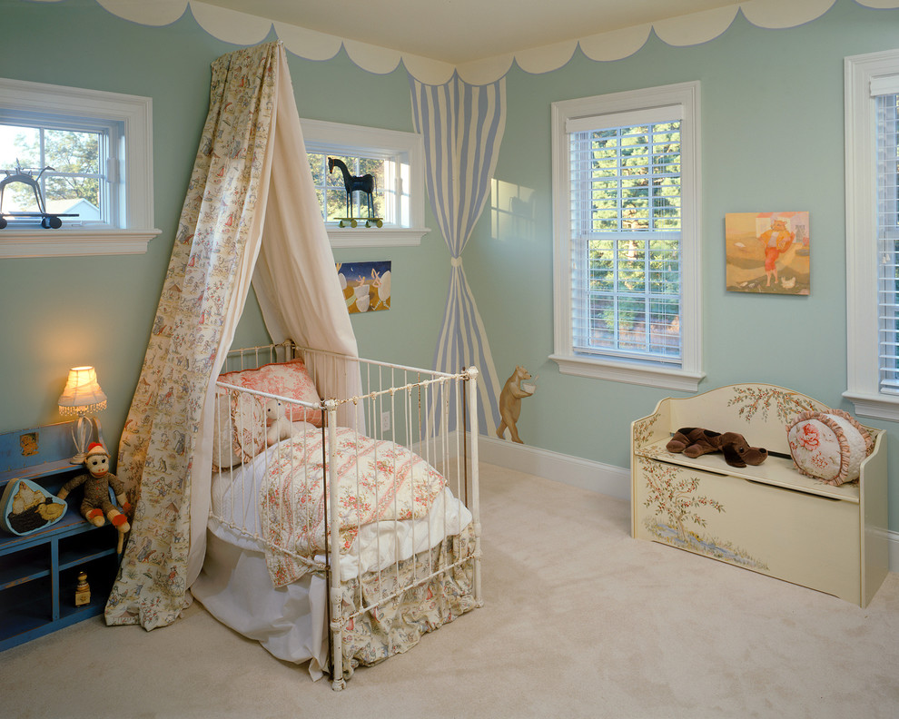 This is an example of a traditional nursery for girls in New York with blue walls and carpet.