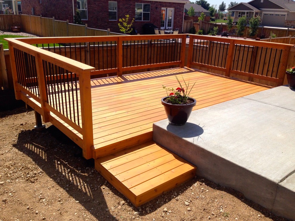 Mid-sized traditional backyard deck in Denver with no cover.