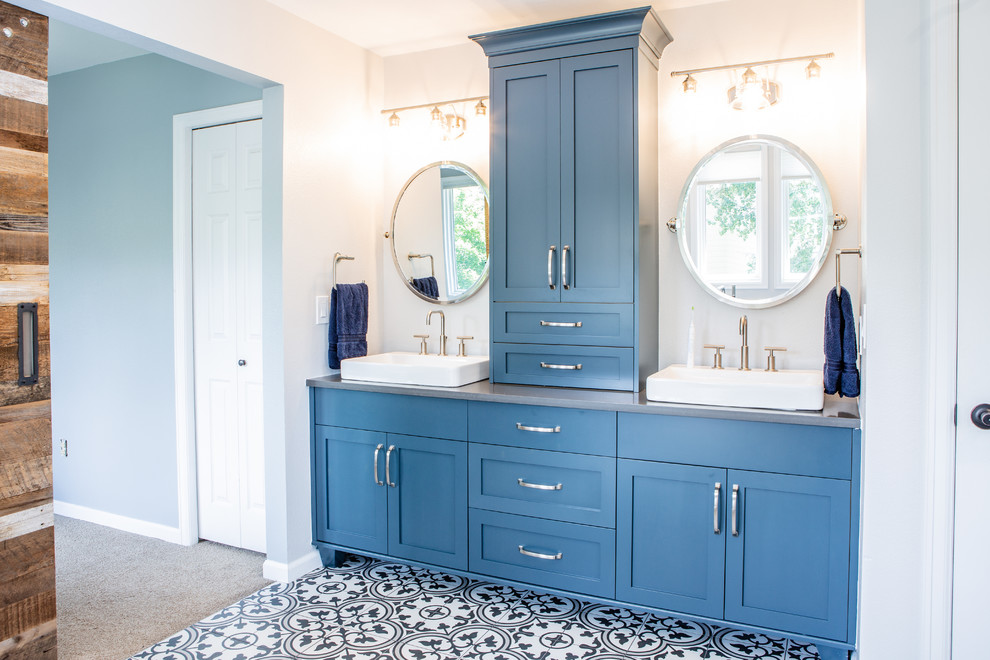 Mid-sized contemporary master bathroom in Denver with shaker cabinets, blue cabinets, a freestanding tub, a curbless shower, a one-piece toilet, white walls, porcelain floors, a vessel sink, soapstone benchtops, white floor, a hinged shower door and grey benchtops.