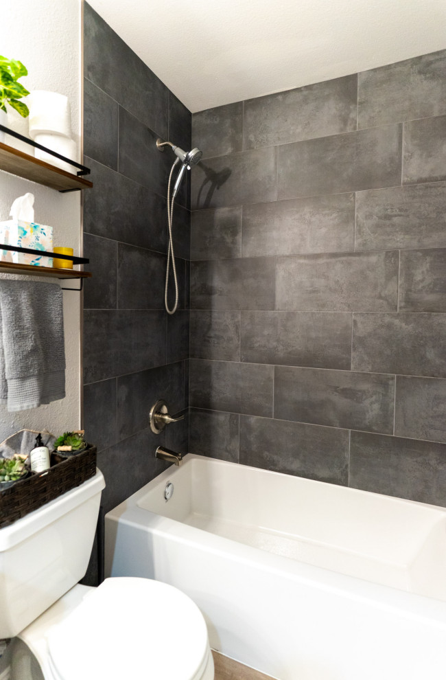 Photo of a medium sized modern ensuite bathroom in Los Angeles with an alcove shower, black tiles, porcelain tiles, white walls, vinyl flooring, beige floors, a shower curtain and a wall niche.