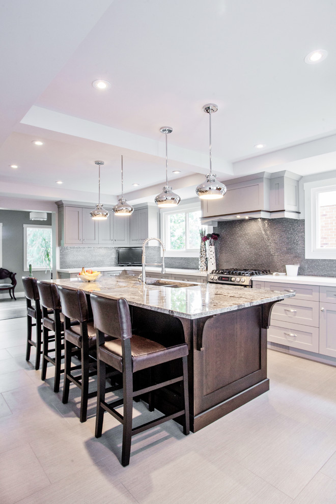Design ideas for a transitional u-shaped kitchen in Toronto with a double-bowl sink, shaker cabinets, beige cabinets, metallic splashback, stainless steel appliances and beige floor.