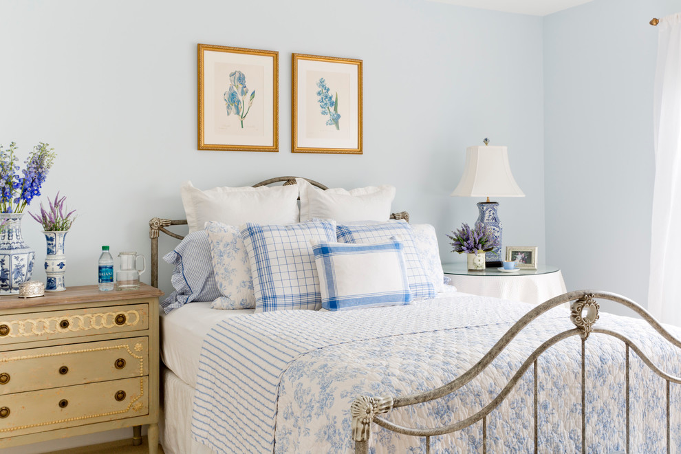 Traditional bedroom in New York with blue walls.