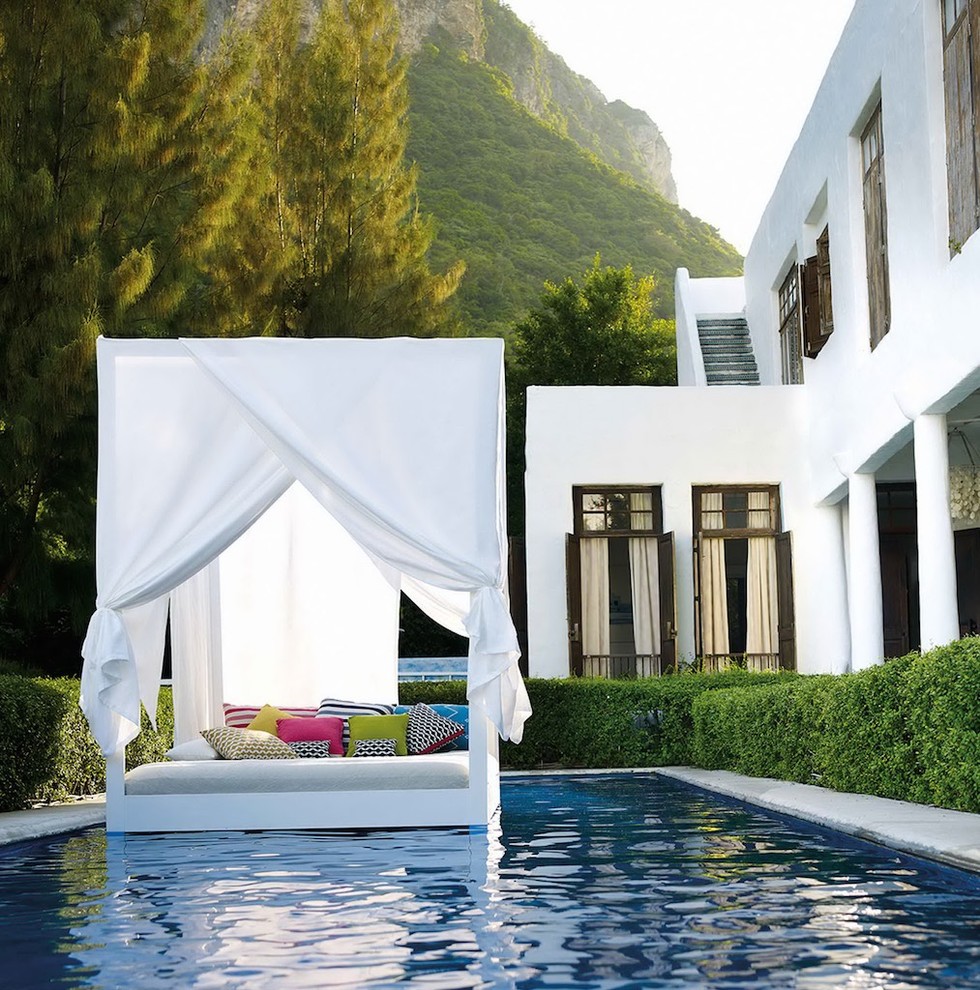 Mid-sized mediterranean backyard rectangular lap pool in Frankfurt with a pool house and concrete slab.