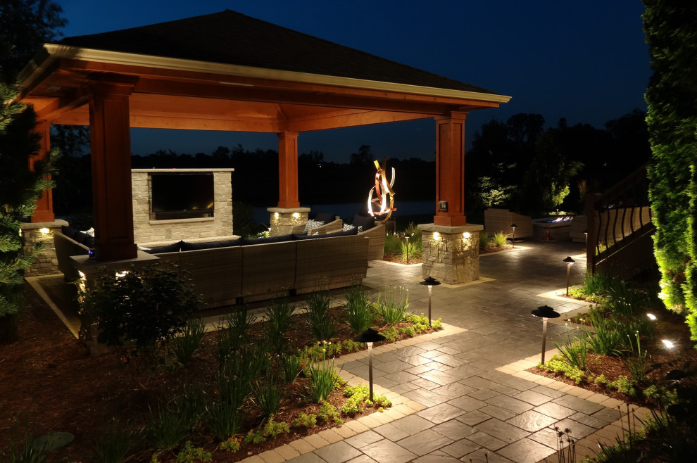 Design ideas for a traditional backyard patio in Chicago with a fire feature, concrete pavers and a gazebo/cabana.