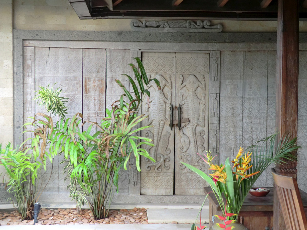 Inspiration for a tropical entryway in Hawaii with a double front door and a gray front door.