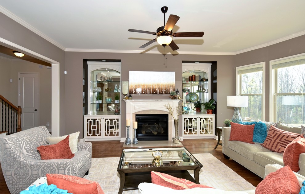 Photo of a mid-sized transitional open concept family room in Atlanta with a home bar, beige walls, dark hardwood floors, a standard fireplace, a wood fireplace surround and no tv.
