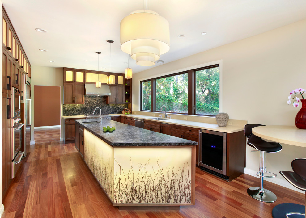This is an example of a contemporary u-shaped eat-in kitchen in San Francisco with shaker cabinets, dark wood cabinets, black splashback and stainless steel appliances.