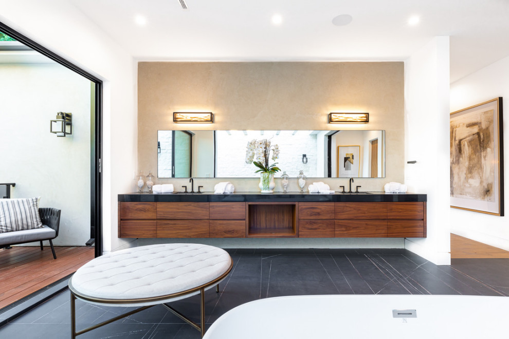 Expansive contemporary master bathroom in Los Angeles with flat-panel cabinets, dark wood cabinets, a freestanding tub, an open shower, white walls, slate floors, an undermount sink, engineered quartz benchtops, black floor, a hinged shower door, black benchtops, a niche, a shower seat, a double vanity, a floating vanity and exposed beam.