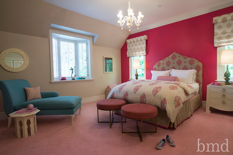 Large transitional kids' bedroom in Los Angeles with pink walls and carpet for girls.