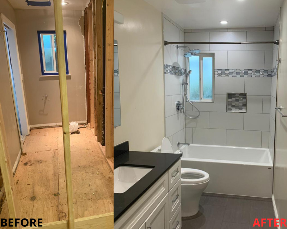 Foto på ett svart badrum, med luckor med upphöjd panel, vita skåp, ett hörnbadkar, vita väggar, målat trägolv, ett undermonterad handfat, bänkskiva i kvartsit och grått golv