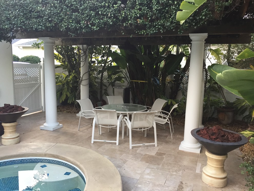Design ideas for a mid-sized mediterranean backyard patio in Tampa with tile.