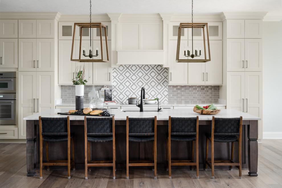 Enclosed kitchen - mid-sized country galley dark wood floor enclosed kitchen idea in Indianapolis with an undermount sink, shaker cabinets, white cabinets, quartz countertops, multicolored backsplash, stainless steel appliances, an island and white countertops