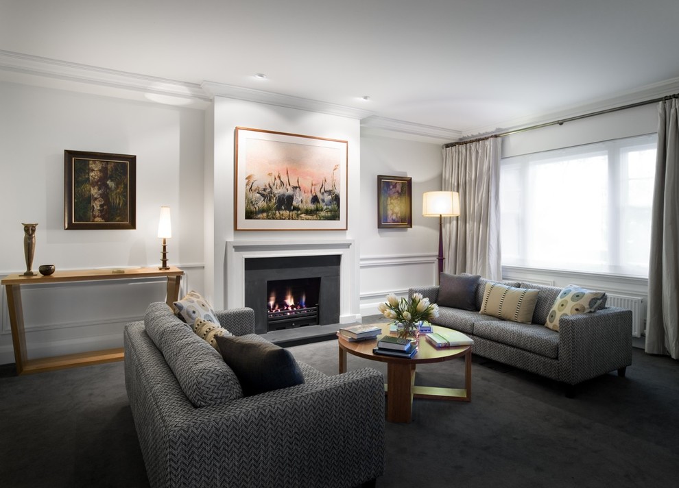 Inspiration for a large contemporary formal enclosed living room in Melbourne with white walls, carpet, a standard fireplace, a concrete fireplace surround, no tv and grey floor.