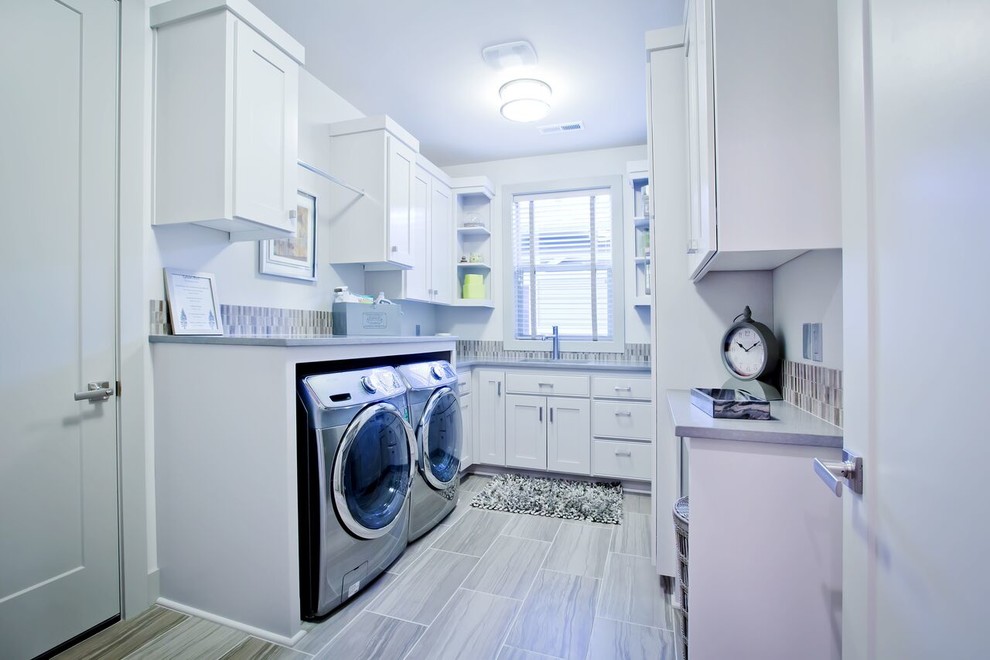 This is an example of a large country u-shaped laundry room in Portland with recessed-panel cabinets, white cabinets, white walls and a side-by-side washer and dryer.
