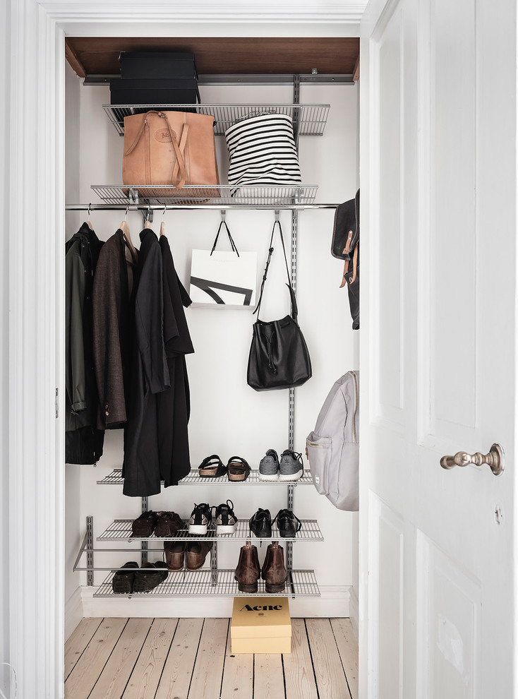 Photo of a small scandinavian gender-neutral storage and wardrobe in Gothenburg with open cabinets.