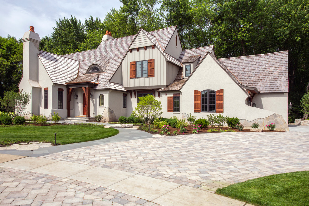 Inspiration for a huge timeless white two-story stucco gable roof remodel in Chicago