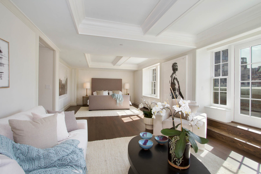 Photo of a large transitional master bedroom in New York with white walls, dark hardwood floors and no fireplace.