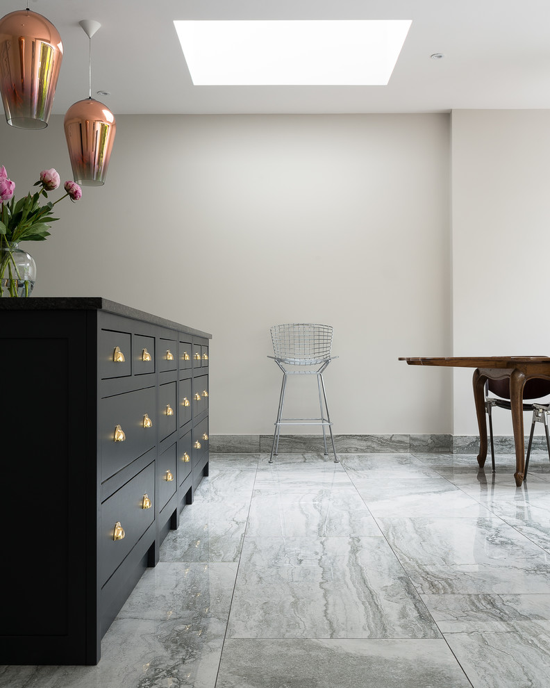 Photo of a large traditional open plan kitchen in London with shaker cabinets, quartz benchtops, marble floors and with island.