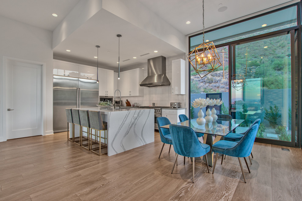 Inspiration for a mid-sized contemporary open plan dining in Phoenix with white walls, medium hardwood floors and brown floor.