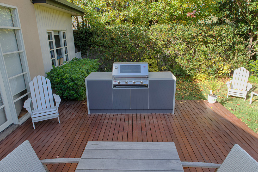 Photo of a contemporary backyard deck in Melbourne with an outdoor kitchen and no cover.