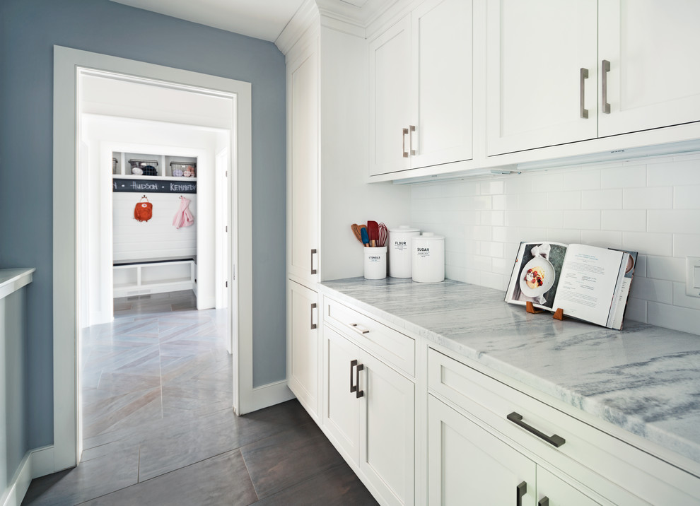 Design ideas for a mid-sized transitional single-wall kitchen pantry in New York with beaded inset cabinets, white cabinets, marble benchtops, white splashback, subway tile splashback, dark hardwood floors and with island.