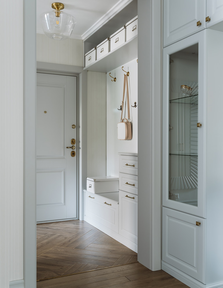 Photo of a mid-sized transitional entry hall in Moscow with grey walls, porcelain floors, a single front door, a gray front door and brown floor.
