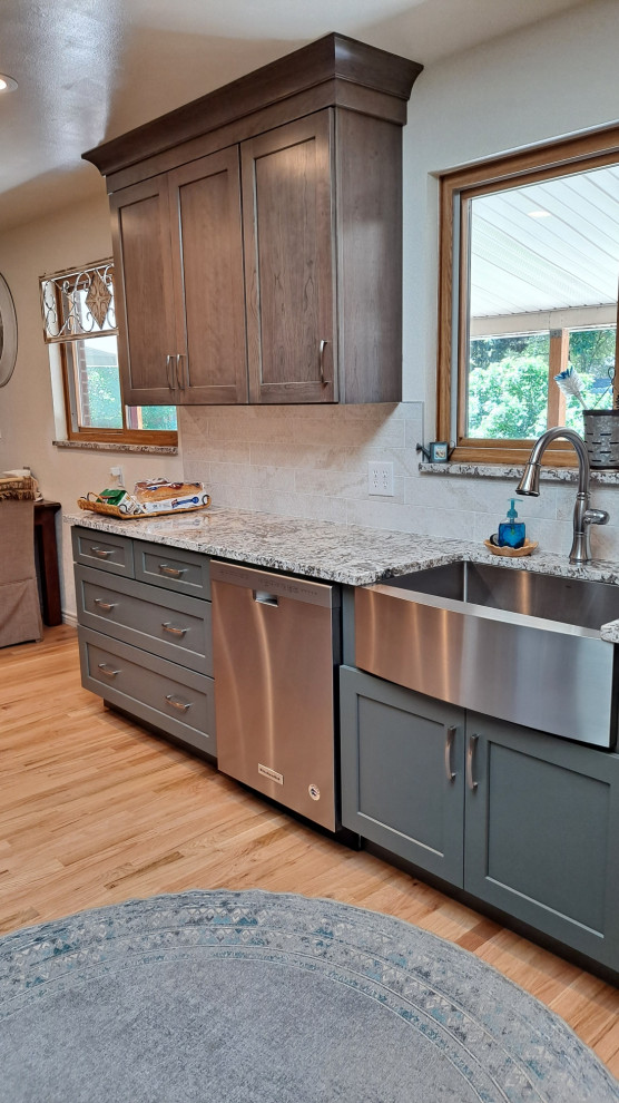 Example of a mid-sized transitional galley light wood floor kitchen design in Denver with shaker cabinets, porcelain backsplash and stainless steel appliances