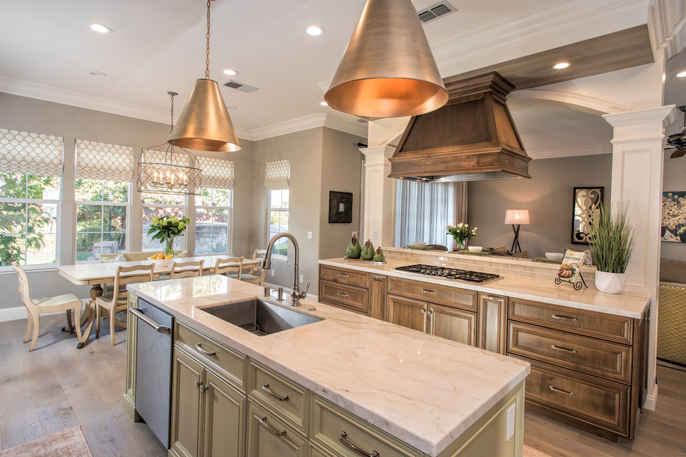 Inspiration for a large transitional light wood floor kitchen remodel in San Francisco with an undermount sink, recessed-panel cabinets, medium tone wood cabinets, quartzite countertops, green backsplash, glass tile backsplash, paneled appliances, two islands and multicolored countertops