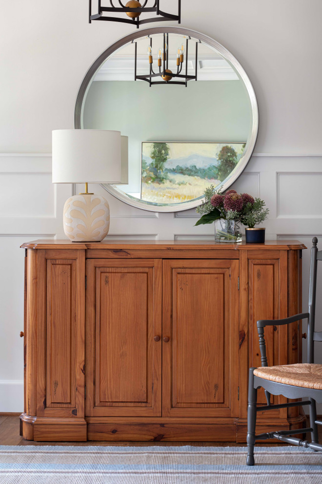 Photo of a large arts and crafts foyer in Richmond with white walls, medium hardwood floors, a single front door, brown floor and decorative wall panelling.