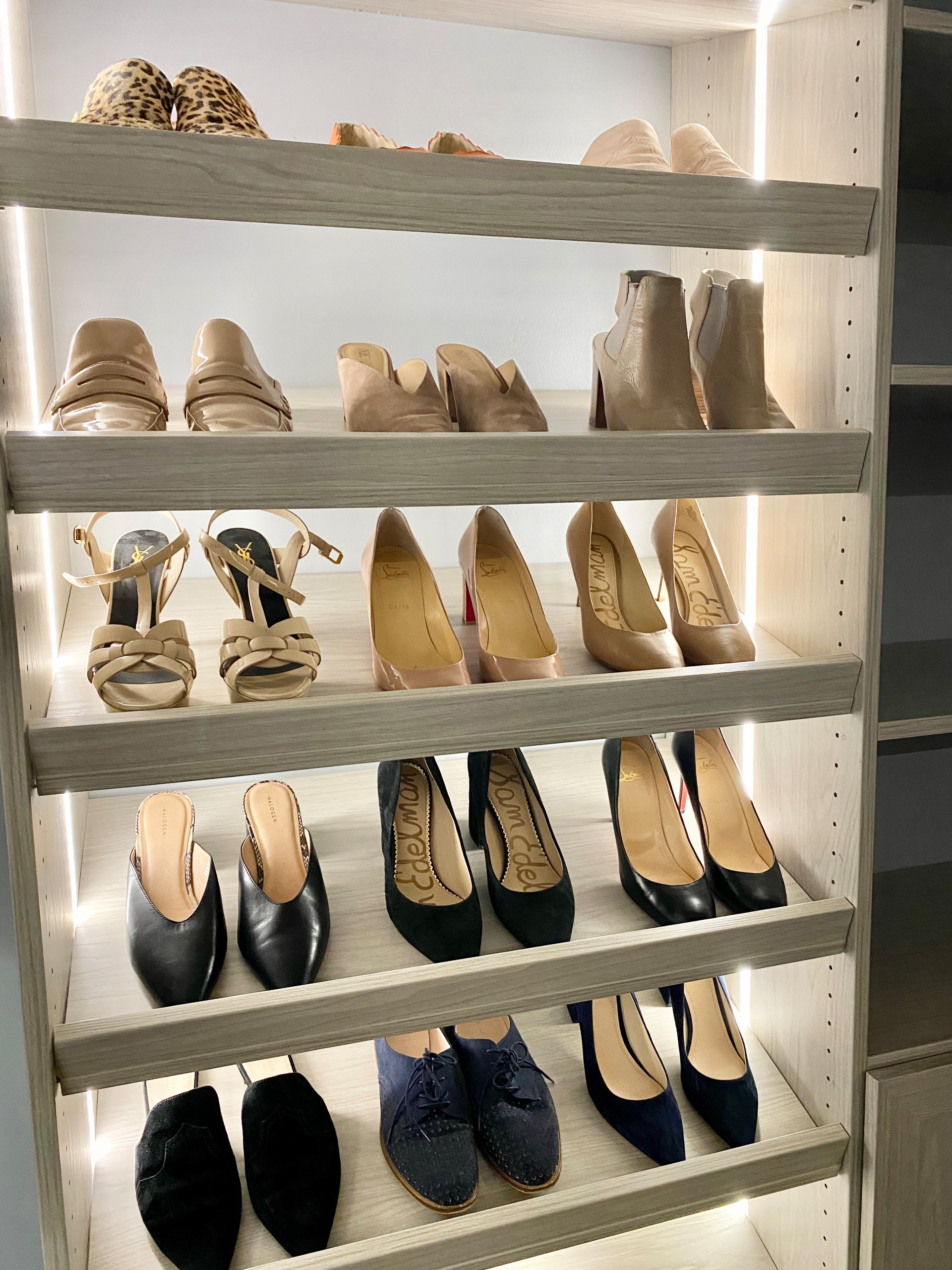 custom closet shoe wall with custom lighting