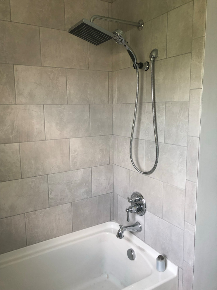 Tub/shower combo - transitional beige tile and stone tile tub/shower combo idea