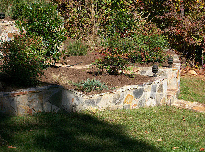 Inspiration for a mid-sized traditional full sun front yard stone driveway in Raleigh for fall.