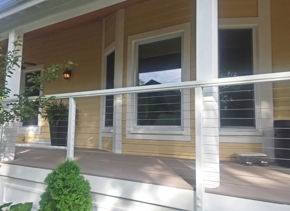 This is an example of a transitional side yard verandah in Seattle with decking and a roof extension.