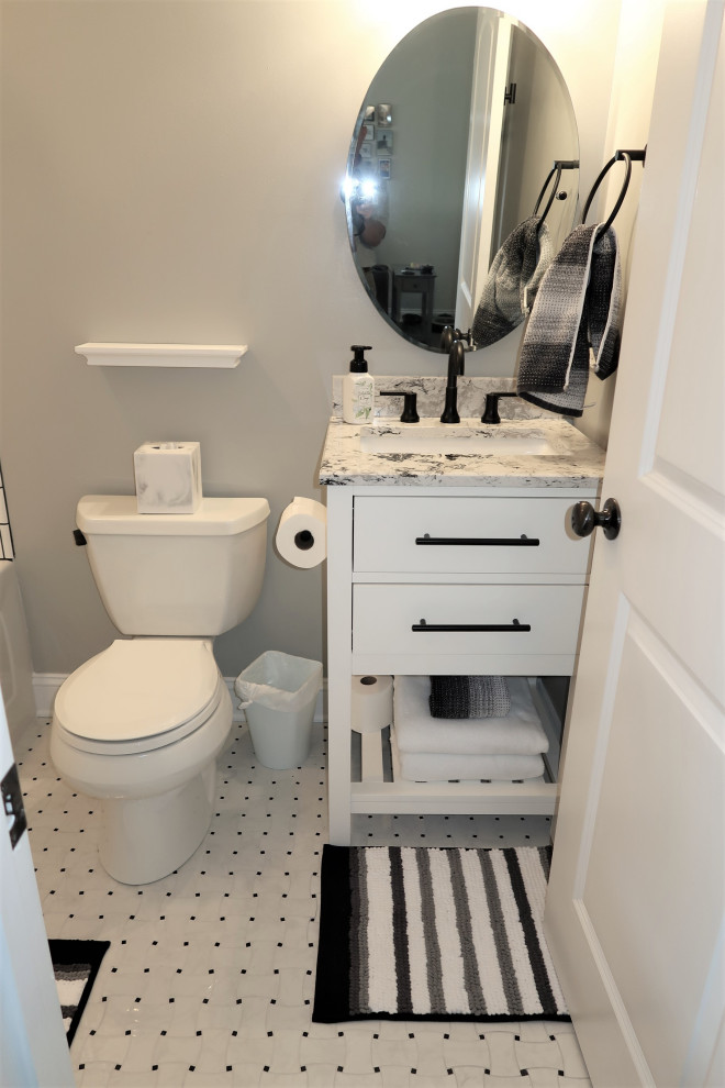 Photo of a mid-sized modern master bathroom in Other with white cabinets, an alcove tub, a shower/bathtub combo, a two-piece toilet, white tile, ceramic tile, grey walls, laminate floors, an undermount sink, quartzite benchtops, white floor, a shower curtain, white benchtops, a single vanity and a freestanding vanity.