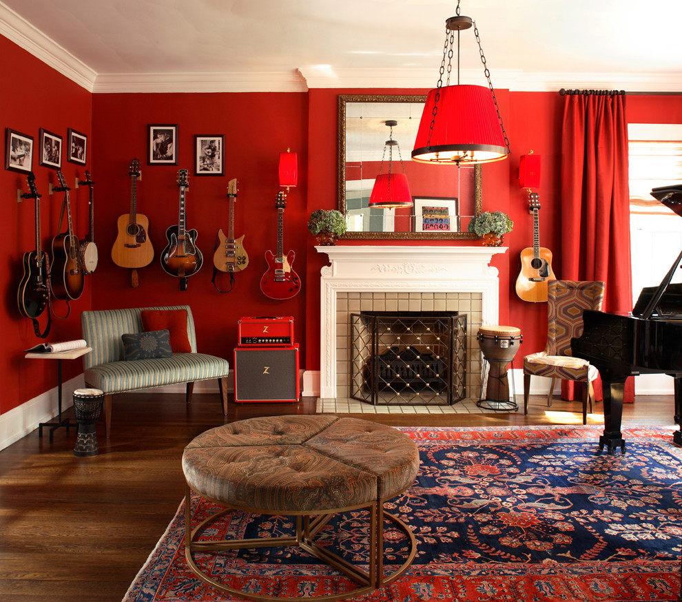 Photo of an eclectic living room in Atlanta with a music area, red walls, dark hardwood floors, a standard fireplace and a stone fireplace surround.