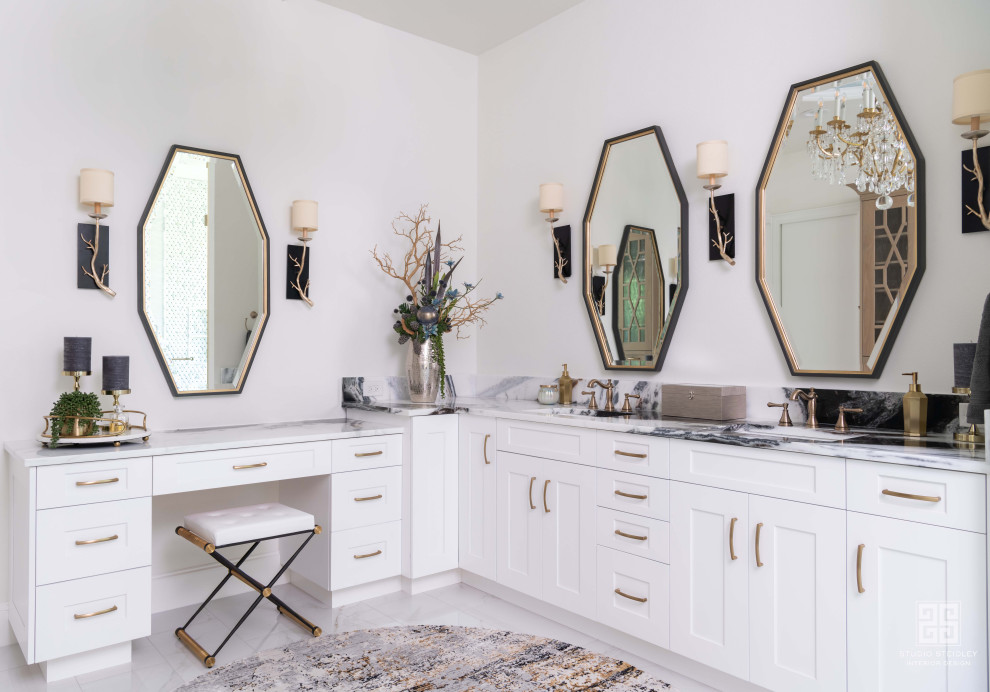 This is an example of a mid-sized transitional master bathroom in Dallas with shaker cabinets, white cabinets, a freestanding tub, an alcove shower, a wall-mount toilet, white tile, white walls, marble floors, an undermount sink, marble benchtops, white floor, an open shower, multi-coloured benchtops, a shower seat, a double vanity and a built-in vanity.
