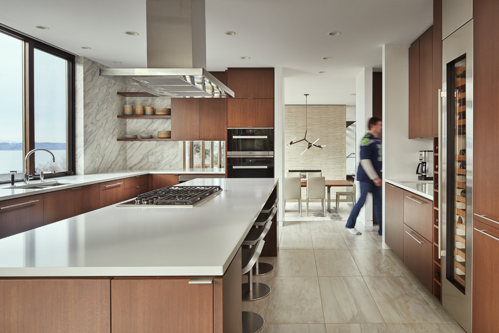 Mid-sized trendy galley porcelain tile and beige floor eat-in kitchen photo in Seattle with a single-bowl sink, flat-panel cabinets, medium tone wood cabinets, marble countertops, gray backsplash, stainless steel appliances, an island and marble backsplash