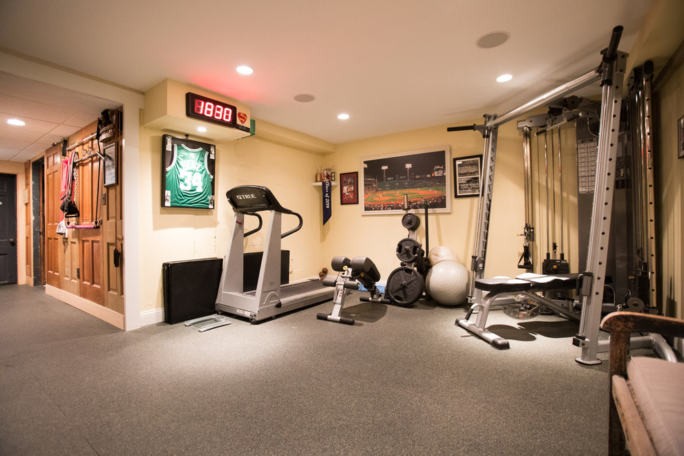 This is an example of a mid-sized traditional home weight room in Boston with beige walls and carpet.
