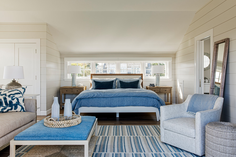 This is an example of a large beach style guest bedroom in Boston with vaulted, planked wall panelling, beige walls, dark hardwood floors and brown floor.