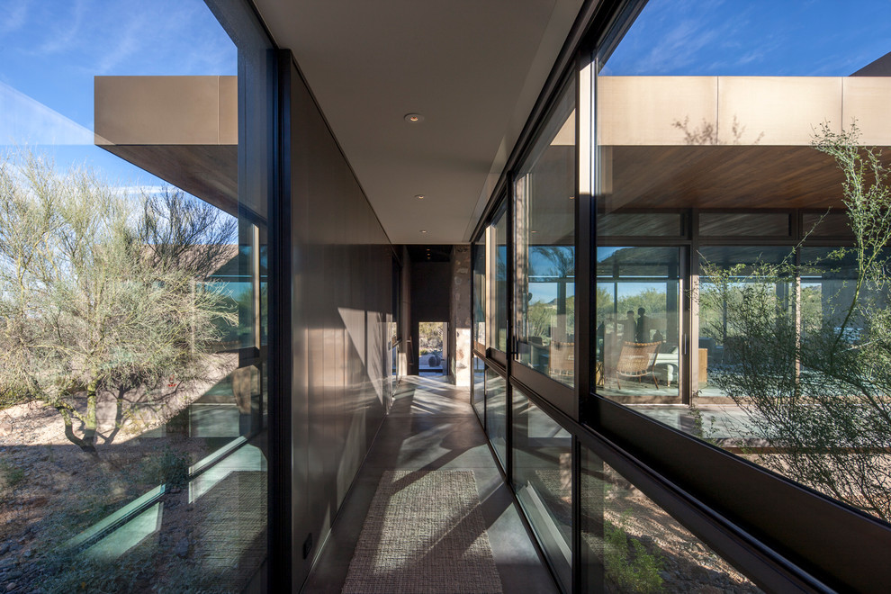 This is an example of a modern hallway in Phoenix with concrete floors.