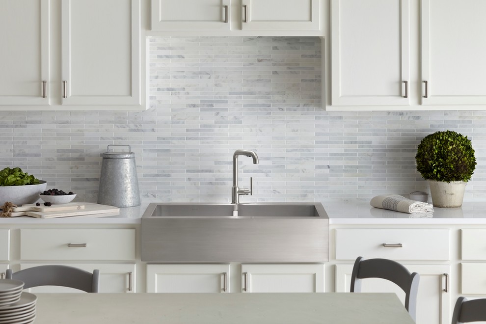 Modern single-wall separate kitchen in Milwaukee with a drop-in sink, beaded inset cabinets, white cabinets, quartzite benchtops, grey splashback and mosaic tile splashback.