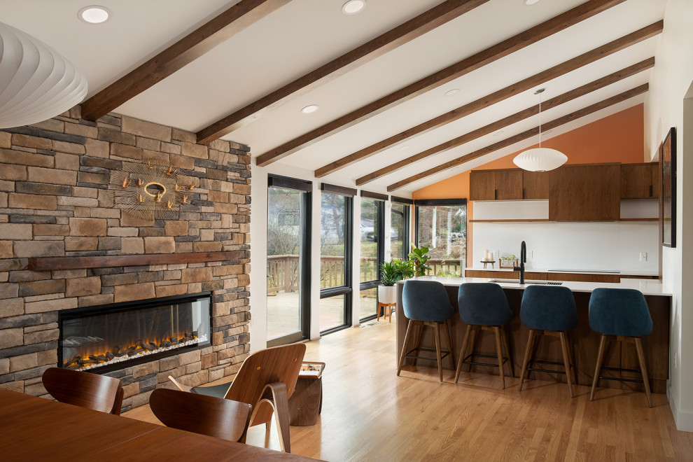 Mid-sized midcentury open concept living room in Other with orange walls, light hardwood floors, a standard fireplace and vaulted.