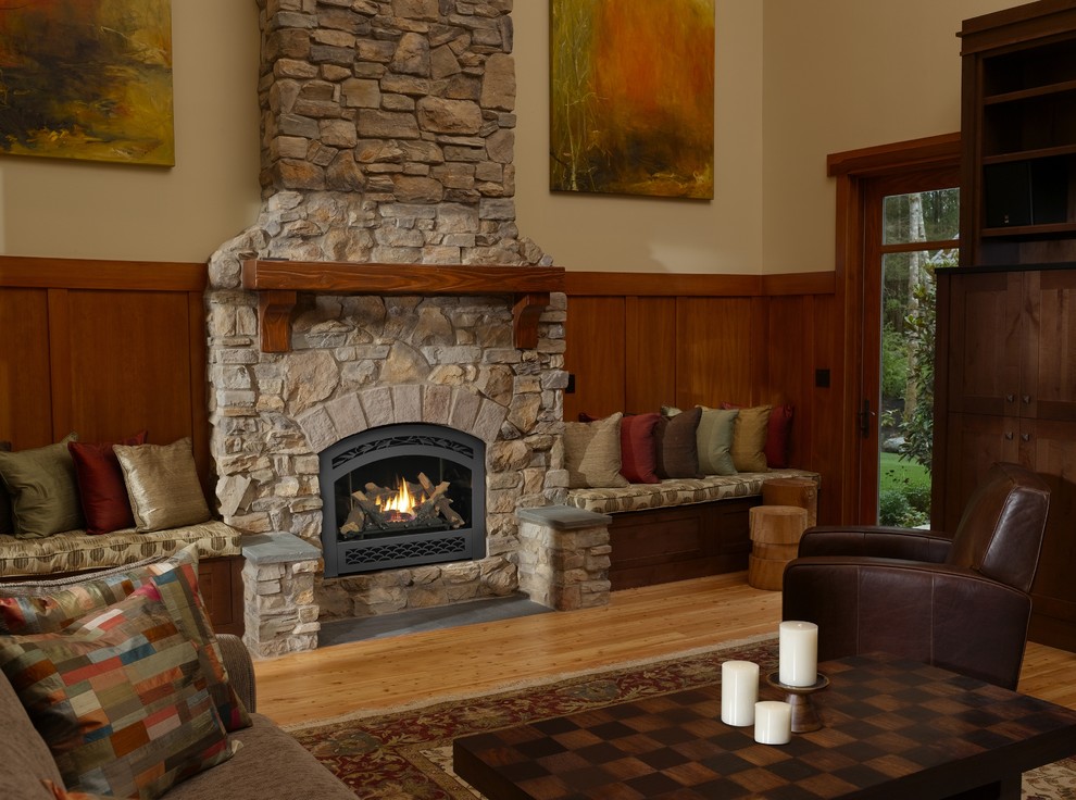 Inspiration for a mid-sized country open concept living room in Other with beige walls, medium hardwood floors, a standard fireplace, a stone fireplace surround and beige floor.