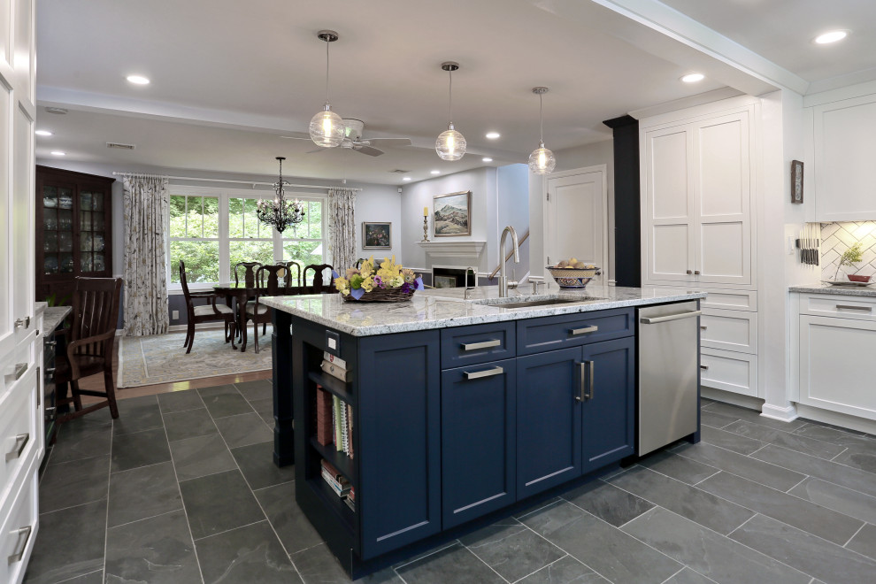 Design ideas for a mid-sized transitional u-shaped eat-in kitchen in Boston with an undermount sink, shaker cabinets, blue cabinets, granite benchtops, white splashback, porcelain splashback, stainless steel appliances, slate floors, with island, grey floor and grey benchtop.
