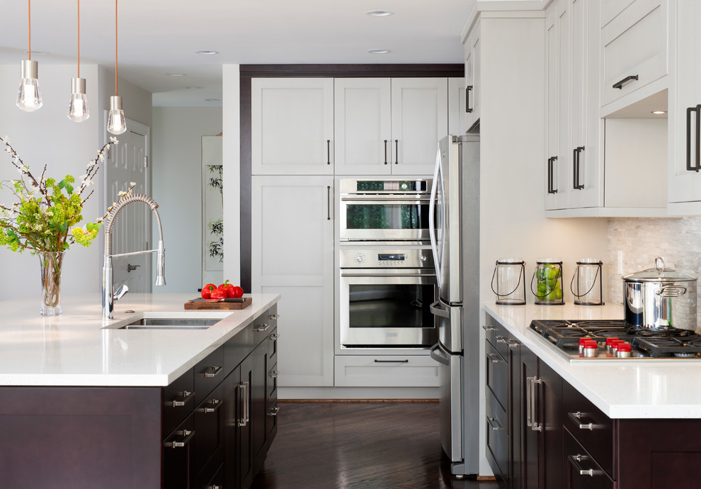 Open concept kitchen - large transitional l-shaped dark wood floor open concept kitchen idea in DC Metro with an island, a double-bowl sink, shaker cabinets, gray cabinets, quartz countertops, beige backsplash, mosaic tile backsplash and stainless steel appliances