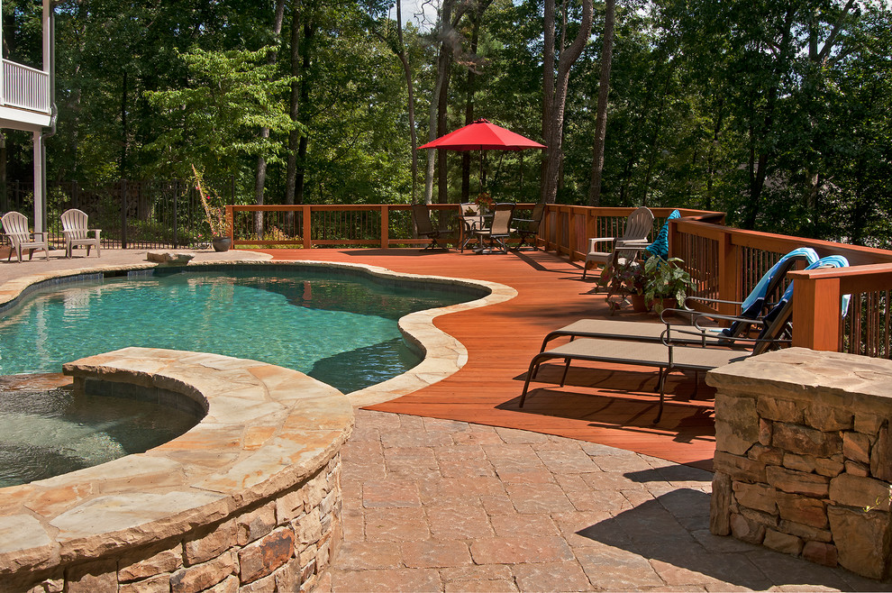 Example of a transitional backyard deck design in Atlanta