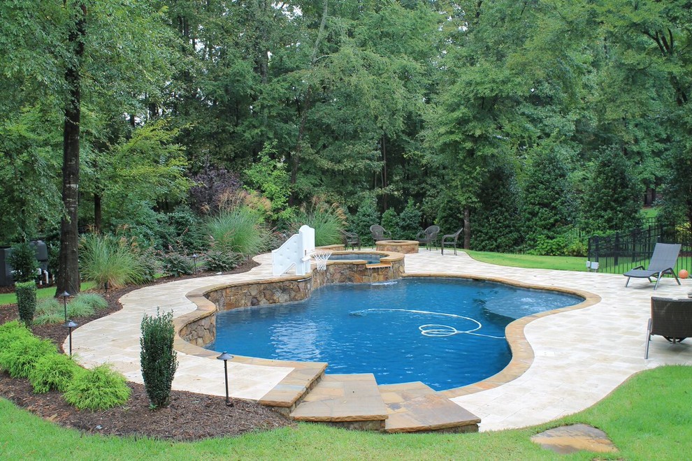 Inspiration for a large transitional backyard stone and custom-shaped lap pool remodel in Charlotte