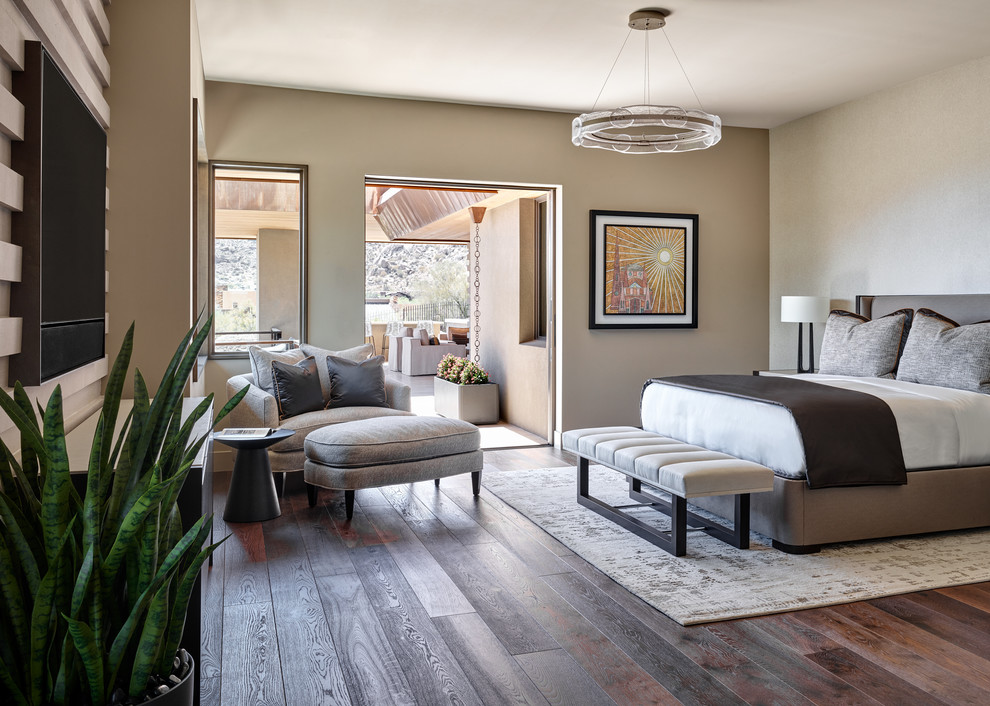 Photo of a large master bedroom in Phoenix with beige walls, dark hardwood floors and brown floor.