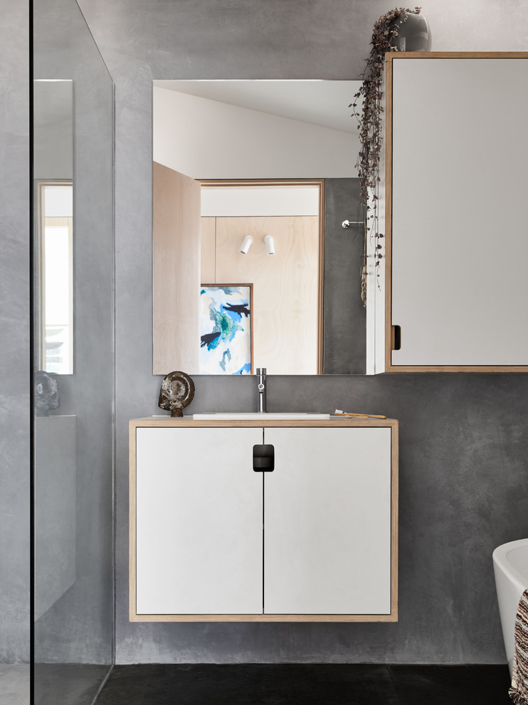 Inspiration for a contemporary 3/4 bathroom in Melbourne with flat-panel cabinets, white cabinets, an open shower, grey walls, a drop-in sink, an open shower, a freestanding tub, a one-piece toilet, concrete floors, wood benchtops and grey floor.